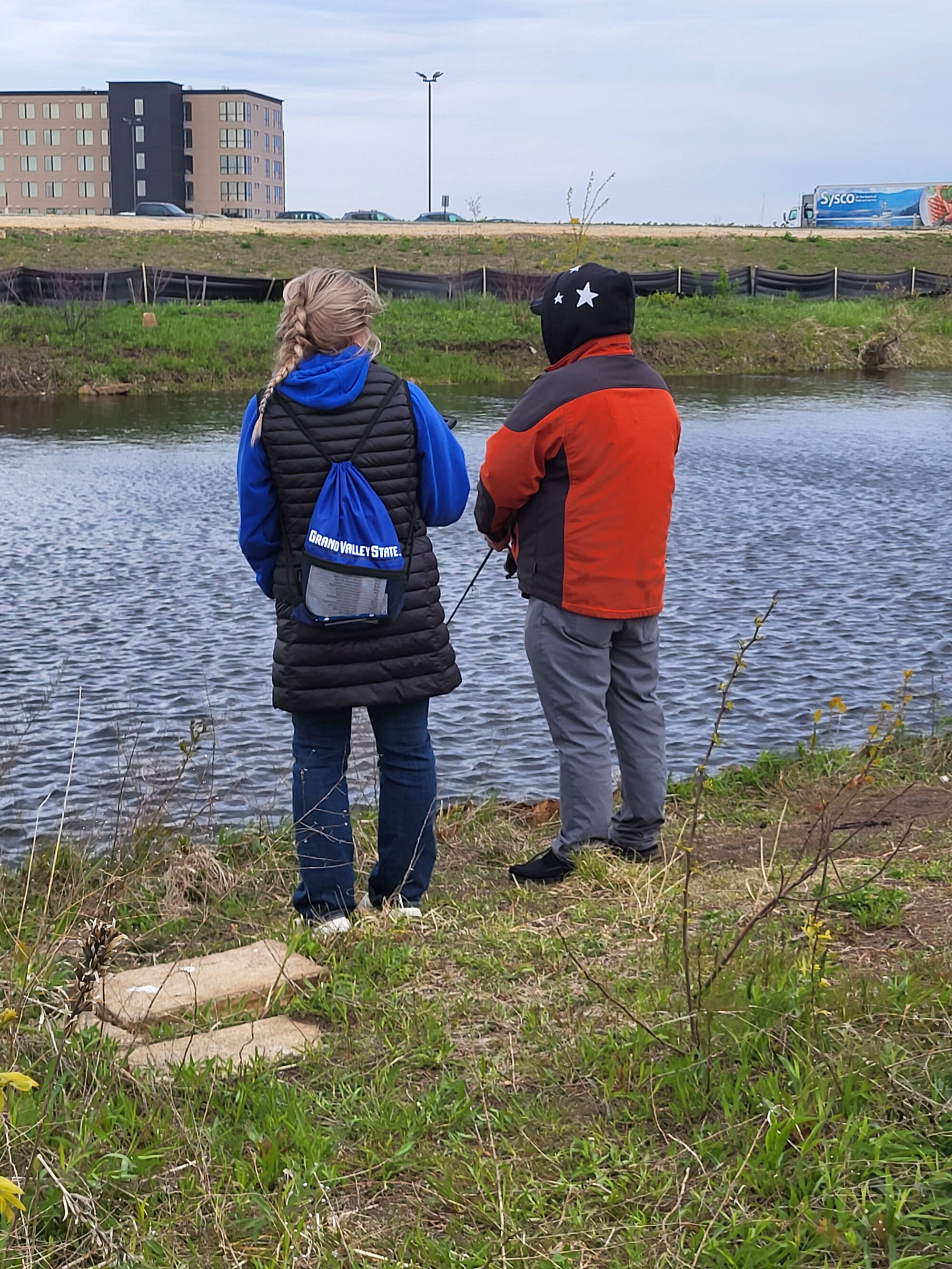 A research assistant interviews anglers along the Muskegon Lake shoreline.